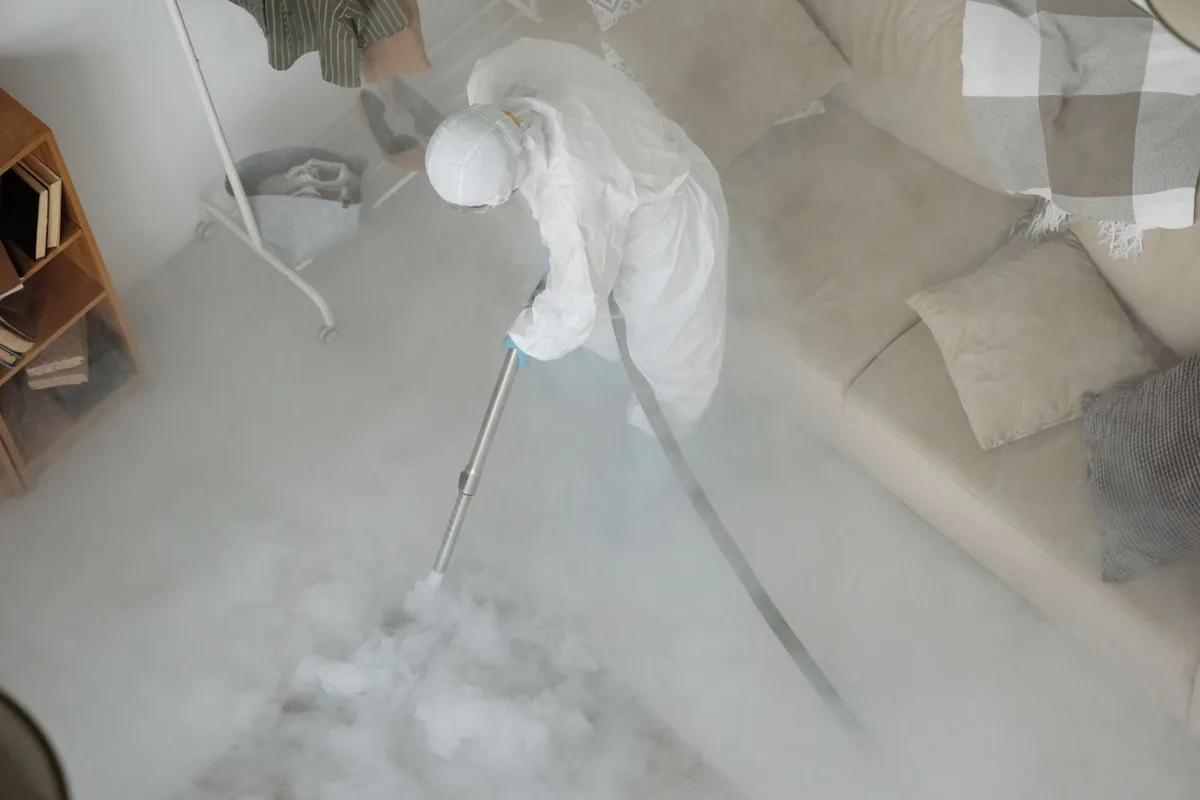 Biohazard cleanup technician in protective equipment, El Dorado, AR